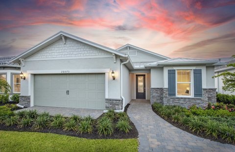 Modern residential home exterior in Englewood, Florida, featuring a landscaped front yard, paved walkway, and stylish architectural details, illustrating the appeal of home renovation.