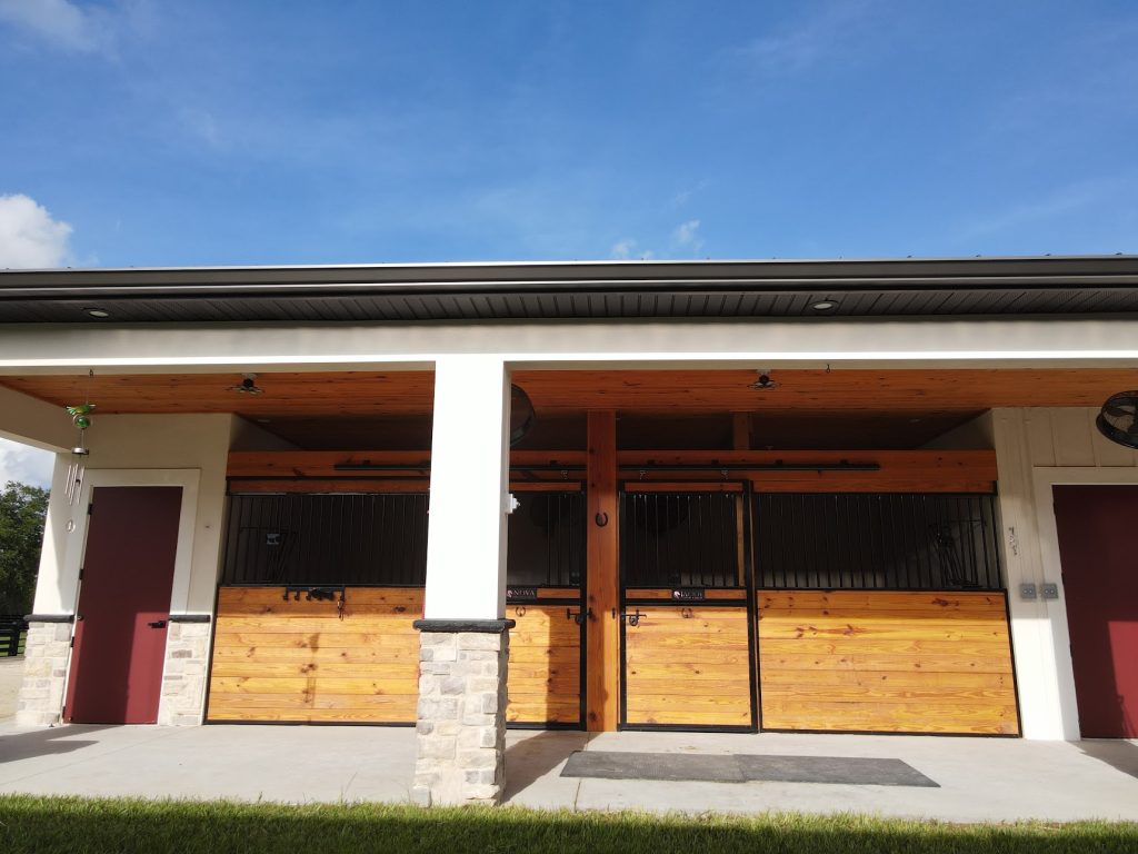 Custom horse barn with covered stalls built by Build Rite Builders on a Southwest Florida equestrian property