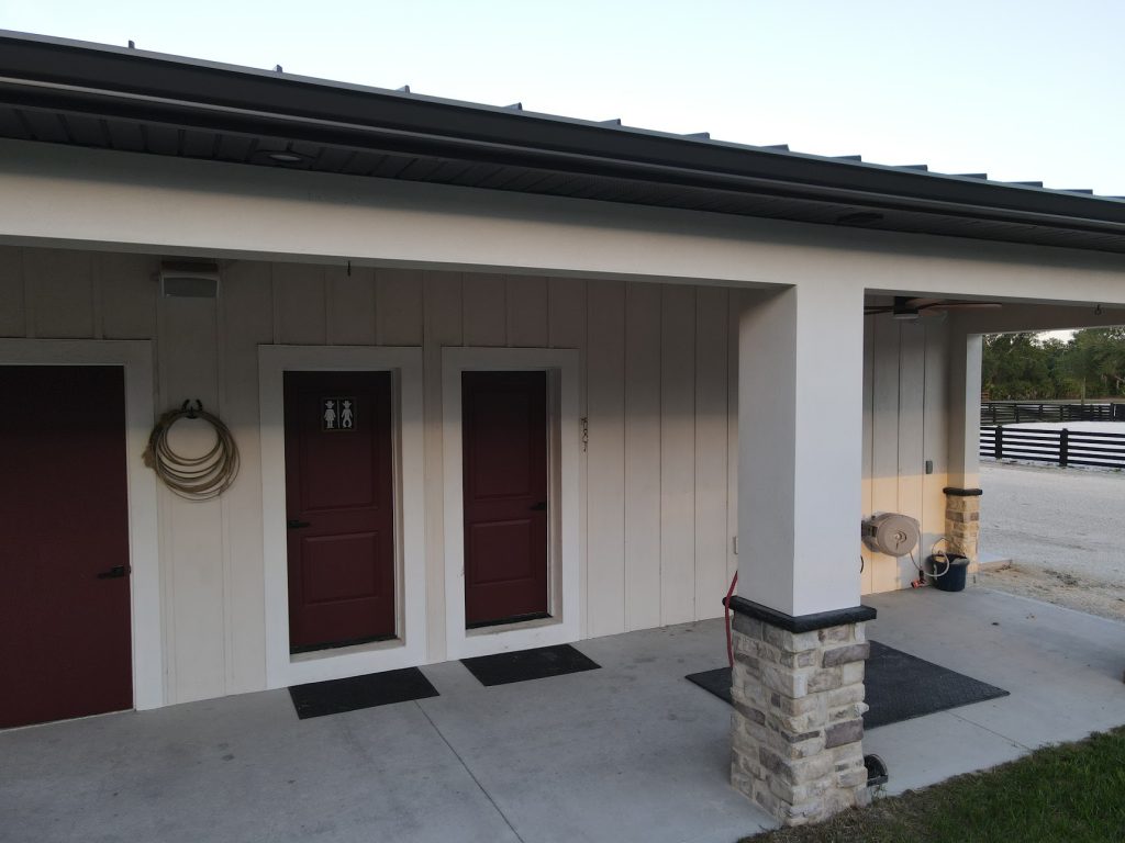 Custom horse barn with covered stalls built by Build Rite Builders on a Southwest Florida equestrian property